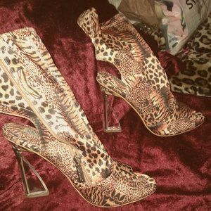 Leopard ankle bootie, w/ a mule clear heel, side zipper, and peep toe. Size 9